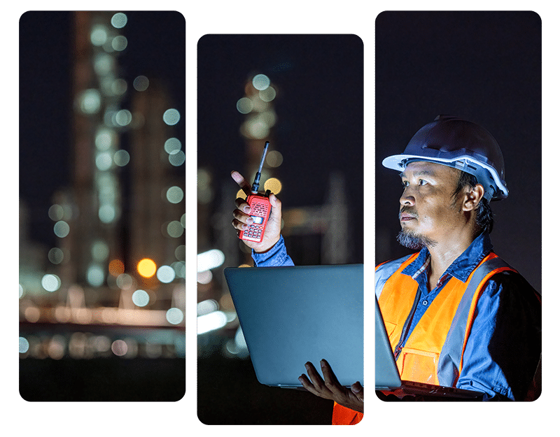 Industrial worker wearing a hard hat and safety vest using a laptop and two-way radio at night, representing EHS compliance monitoring in a facility.